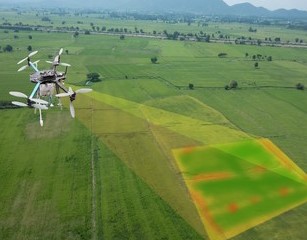 white drone flying recording data high above a field